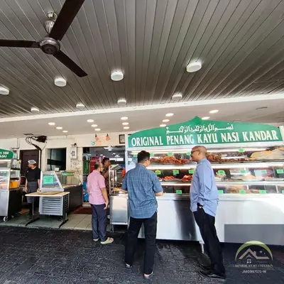a group of people standing at a counter in a supermarket at Minimalist Balcony Duplex w Netflix at Bayan Lepas in Bayan Lepas