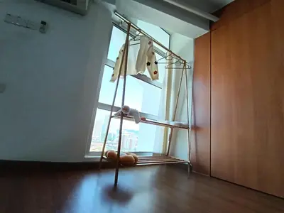 a room with a towel rack in front of a window at Minimalist Balcony Duplex w Netflix at Bayan Lepas in Bayan Lepas