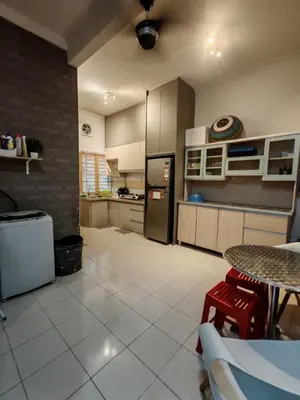 a kitchen with a refrigerator and a table in it at Homestay Sakinah No 39 in Tanjung Malim