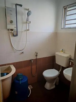 a bathroom with a shower and a toilet and a sink at Homestay Sakinah No 39 in Tanjung Malim