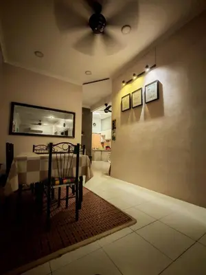 a dining room with a table and a ceiling fan at Homestay Sakinah No 39 in Tanjung Malim
