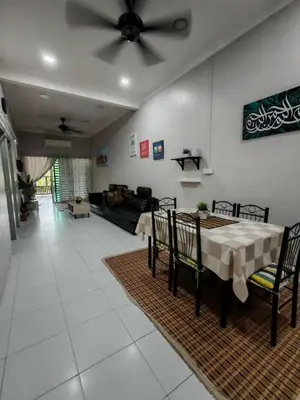 a living room with a table and a couch at Homestay Sakinah No 39 in Tanjung Malim