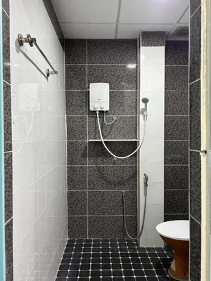 a bathroom with a shower with a toilet and a sink at Ray Yan Guesthouse Penang in Batu Ferringhi