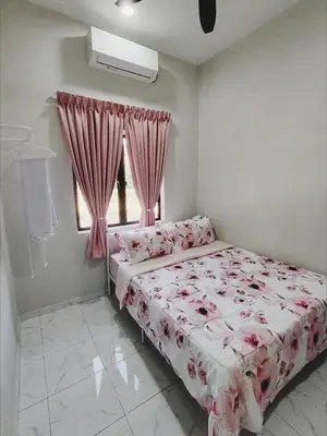 a bedroom with a bed with pink sheets and a window at Homestay De'daun kulim mus'lim only in Kulim