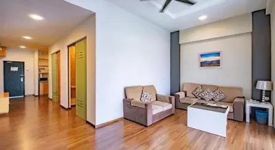 a living room with two couches and a table at Nova hotel in Brinchang