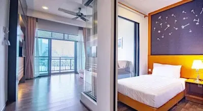 a bedroom with a bed and a large glass window at Nova hotel in Brinchang