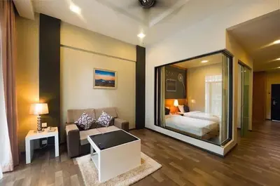 a hotel room with a bed and a large glass window at Nova hotel in Brinchang