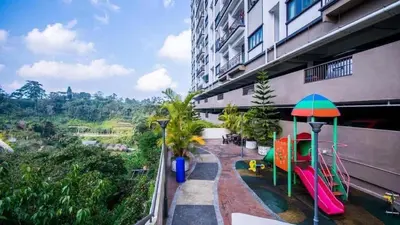 a balcony of a building with a slide and a playground at Nova hotel in Brinchang