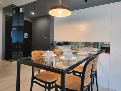 a dining room with a black table and chairs at Stylish Living 2BR Suite in George Town