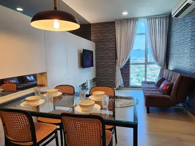 a living room with a table and chairs and a couch at Stylish Living 2BR Suite in George Town