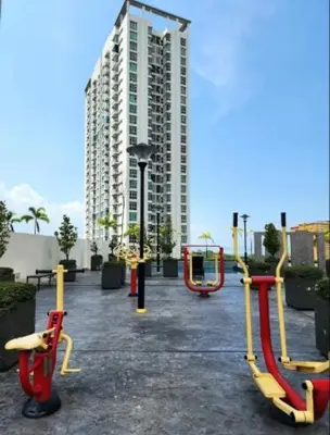 a playground in a park with a large building at Stylish Living 2BR Suite in George Town