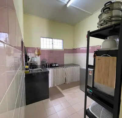 a kitchen with a sink and a counter top at Homestay Ayah Iz Temerloh Jaya in Gua Sai