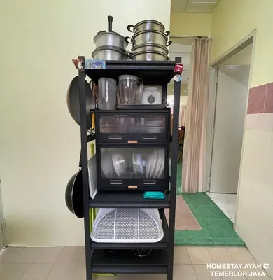 a kitchen cart with pots and pans on it at Homestay Ayah Iz Temerloh Jaya in Gua Sai