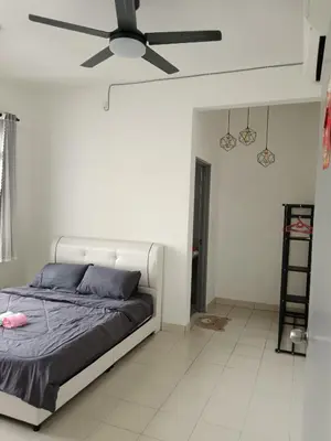 a bedroom with a bed and a ceiling fan at Little sweet in Gua Sai