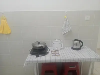 a kitchen table with a stove and a pot and pans at Little sweet in Gua Sai