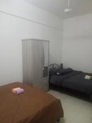 a bedroom with two beds and a cabinet at Little sweet in Gua Sai