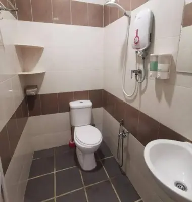 a bathroom with a toilet and a sink at Homestay Lung Tok in Bukit Mertajam