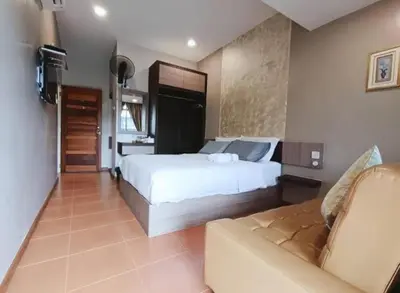 a large bedroom with a bed and a couch at Homestay Lung Tok in Bukit Mertajam