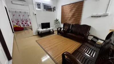 a living room with a couch and a television at D'Simpang Homestay in Sungai Petani