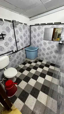a bathroom with a toilet and a tub in a room at D'Simpang Homestay in Sungai Petani