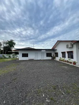 a white building with a large yard in front of it at D'Simpang Homestay in Sungai Petani