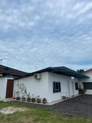 a white house with a blue roof and potted plants at D'Simpang Homestay in Sungai Petani