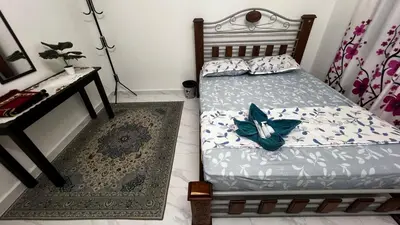 a bedroom with a bed and a desk and a bed sidx sidx sidx at D'Simpang Homestay in Sungai Petani