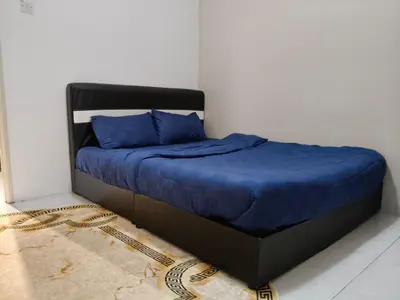 a bed in a room with blue pillows on it at Adila Alfina Heaven Homestay Cameron Highlands in Tanah Rata