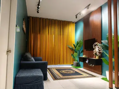 a living room with blue chairs and a yellow curtain at Adila Alfina Heaven Homestay Cameron Highlands in Tanah Rata