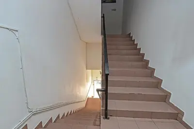a staircase in a building with a stair case at SPOT ON 91178 Motel Impian in Kampong Telok Batu