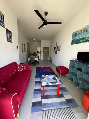 a living room with a red couch and a table at AYAAN Muslimah home at Golden Hill near Night Market in Brinchang