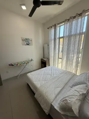 a bedroom with a bed and a large window at AYAAN Muslimah home at Golden Hill near Night Market in Brinchang