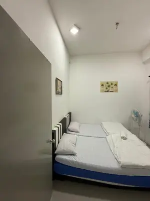 a bedroom with a bed in a white room at AYAAN Muslimah home at Golden Hill near Night Market in Brinchang
