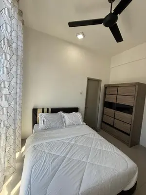 a bedroom with a white bed with a ceiling fan at AYAAN Muslimah home at Golden Hill near Night Market in Brinchang
