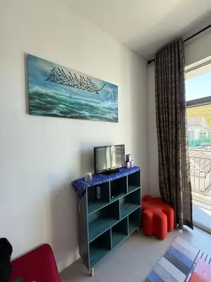 a room with a desk with a tv and a window at AYAAN Muslimah home at Golden Hill near Night Market in Brinchang