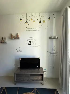 a living room with a wall with stickers on it at AYAAN Tulip Golden Hills Home Near Night Market Free Parking in Brinchang