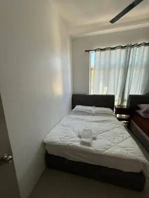 a bedroom with a bed in a room with a window at AYAAN Tulip Golden Hills Home Near Night Market Free Parking in Brinchang