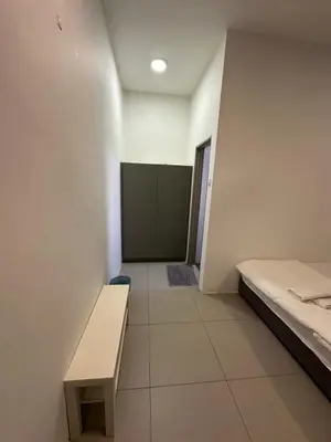a room with a bed and a bench in it at AYAAN PENTHOUSE at Golden Hill Night Market View in Brinchang