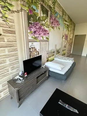 a room with a bed and a tv on a table at AYAAN Lavender Home at Golden Hills near Night Market in Brinchang