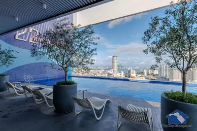 a balcony with chairs and a view of the city at 22 Macalisterz in George Town
