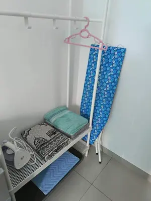 a room with a shelf with a chair and a cushion at Villa Atok Opah in Teluk Intan