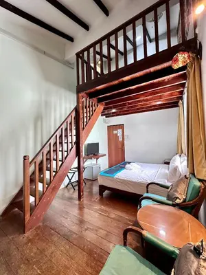 a bedroom with a bunk bed and a staircase at Rangoon Residence 26 in George Town