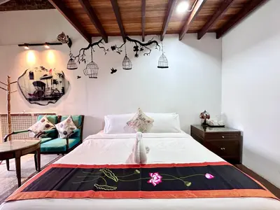 a bedroom with a bed and a living room at Rangoon Residence 26 in George Town