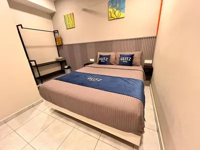 a bedroom with a bed with two pillows on it at Glitz Hotel in Brinchang
