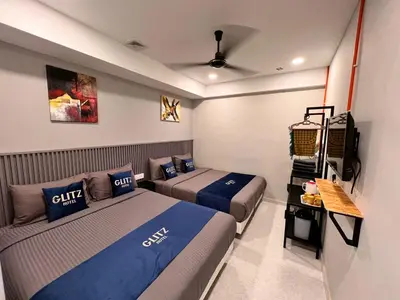 a room with two beds and a television in it at Glitz Hotel in Brinchang