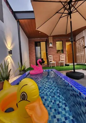 a swimming pool with two rubber ducks in the water at Sun Rimba Home by Ipoh Maju Stay in Ipoh