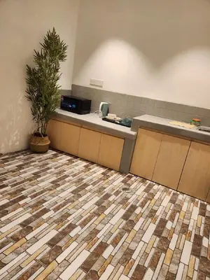a lobby with a counter and a plant in a room at Sun Rimba Home by Ipoh Maju Stay in Ipoh