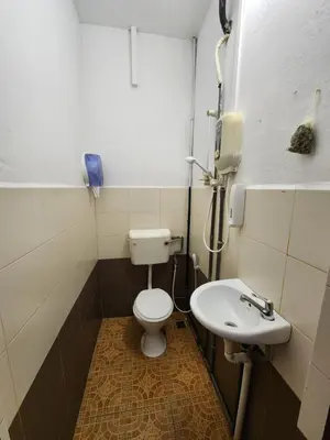 a bathroom with a toilet and a sink at Rasa Motel at Batu Ferringhi in Batu Ferringhi