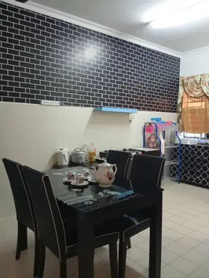 a black table with chairs and a pot on it at Auliya Homestay in Gua Sai
