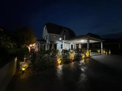 a house lit up at night with lights at Eiffel Villa Homestay Melaka in Gua Sai